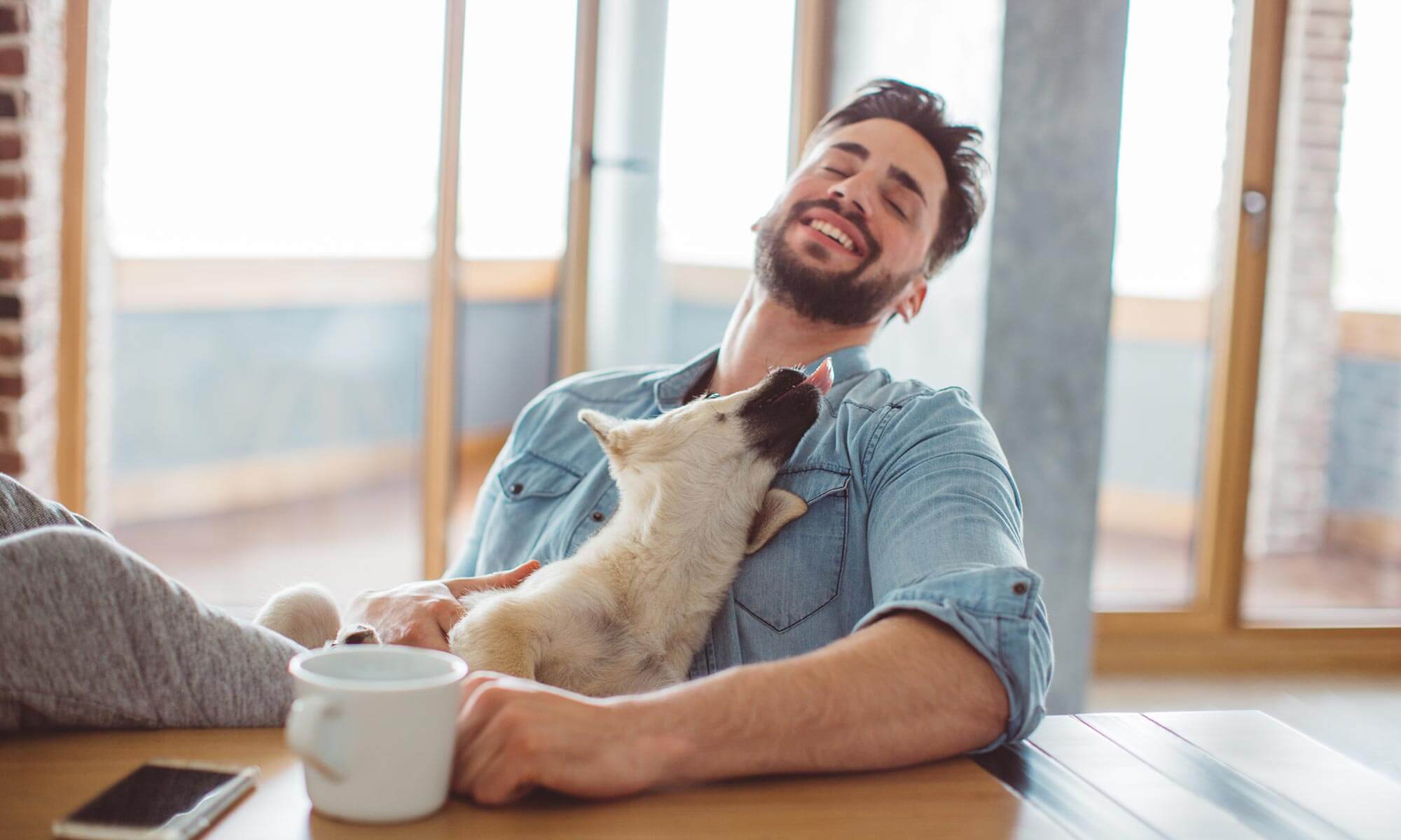 A man sitting with a puppy